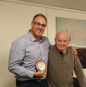 Geoff Lawrence presenting Adrian England with an award